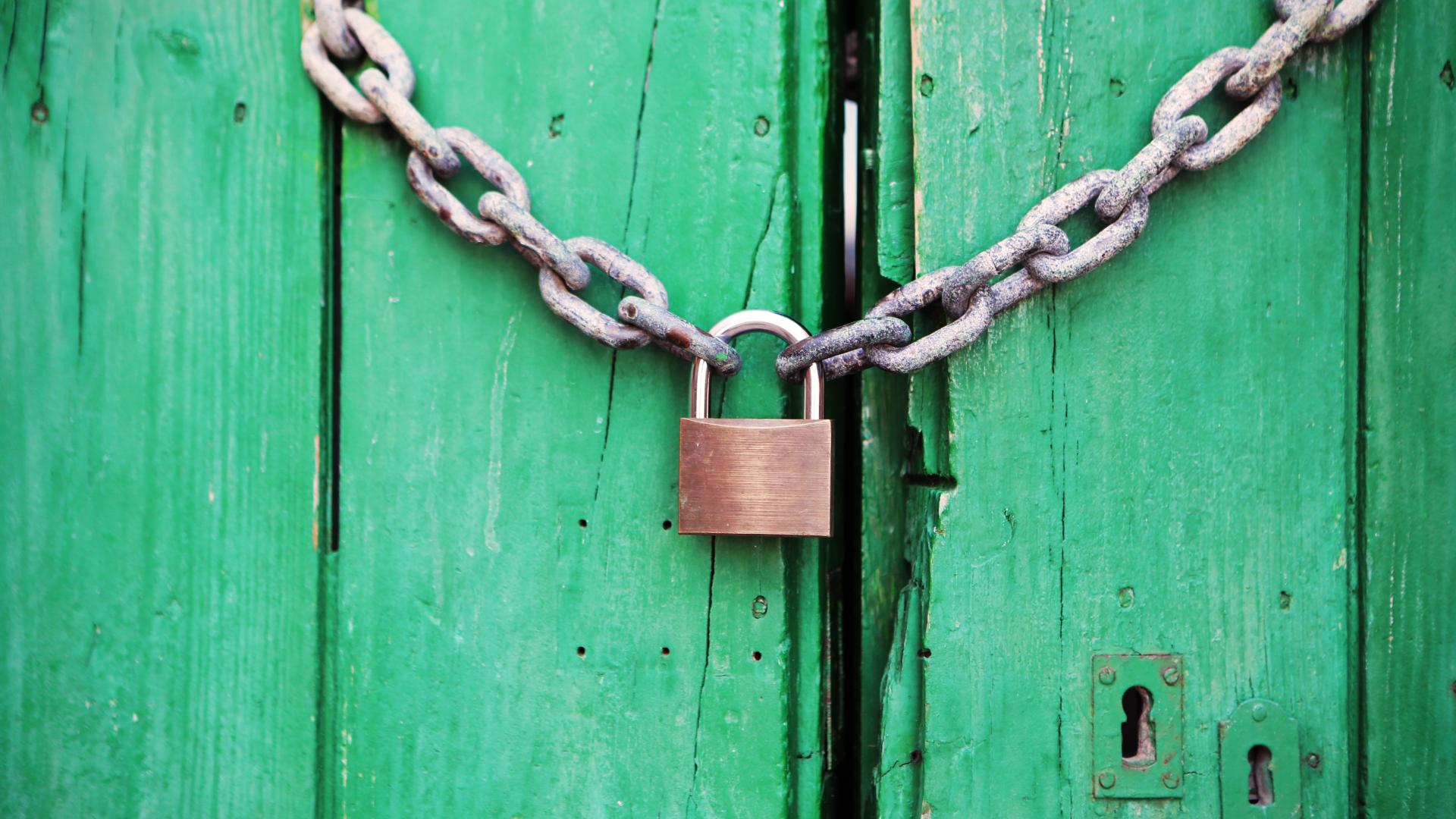 Lock and chain on green door