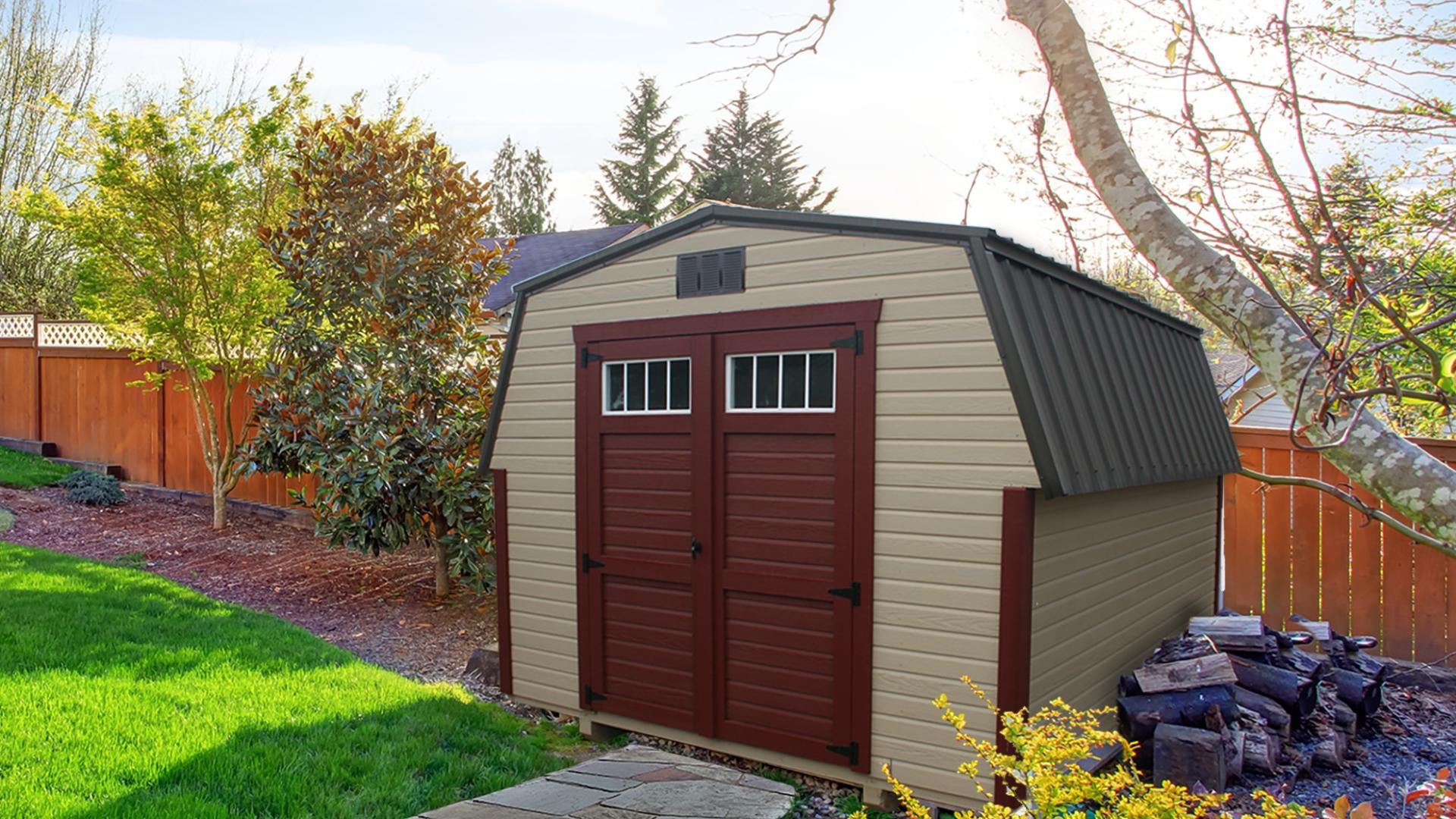 Tan mini barn with red door and trim