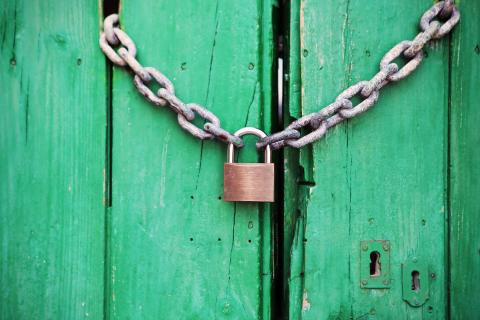 Lock and chain on green door