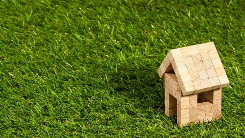 Wooden block house in grass