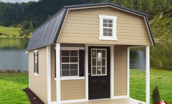 Tan Signature Lofted Cabin with white trim, a black door, and a black roof.